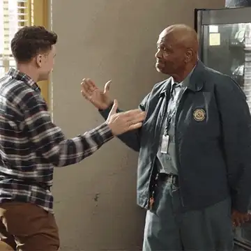 Two people sharing an enthusiastic handshake.